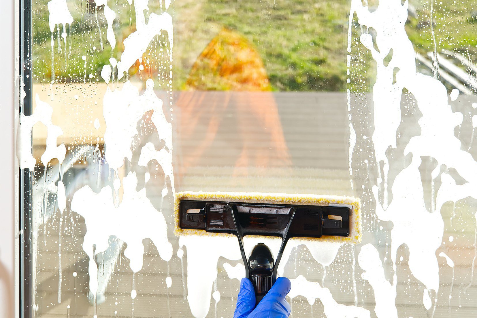Spring washing of a dirty window. service for washing windows in Domestic homes. a woman in blue gloves provides a window cleaning service. Cleaning service concept